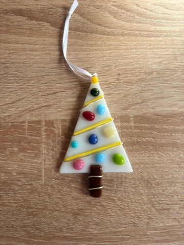 Decorative Christmas tree ornament with colorful beads on a wooden surface