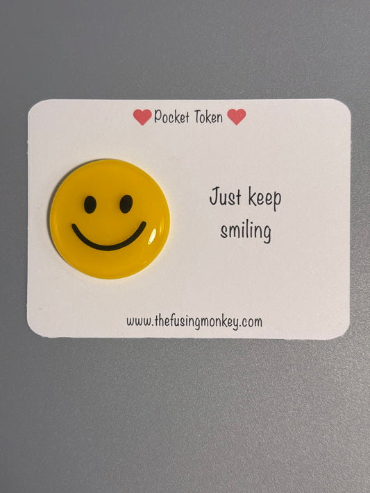 Just keep smiling glass token